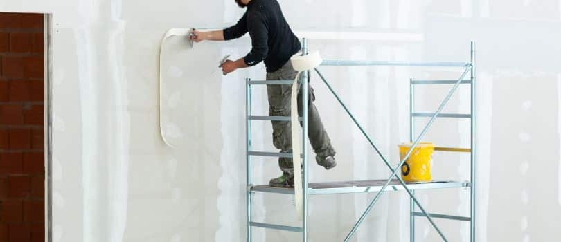 Plasterer concrete worker at wall of house construction stock photo